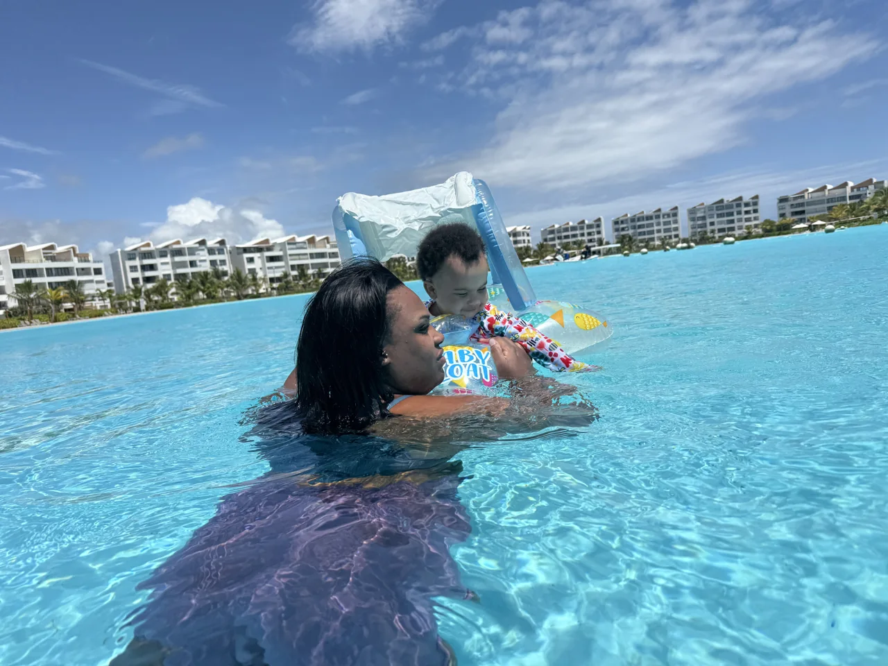 Amia playing with her baby in the pool